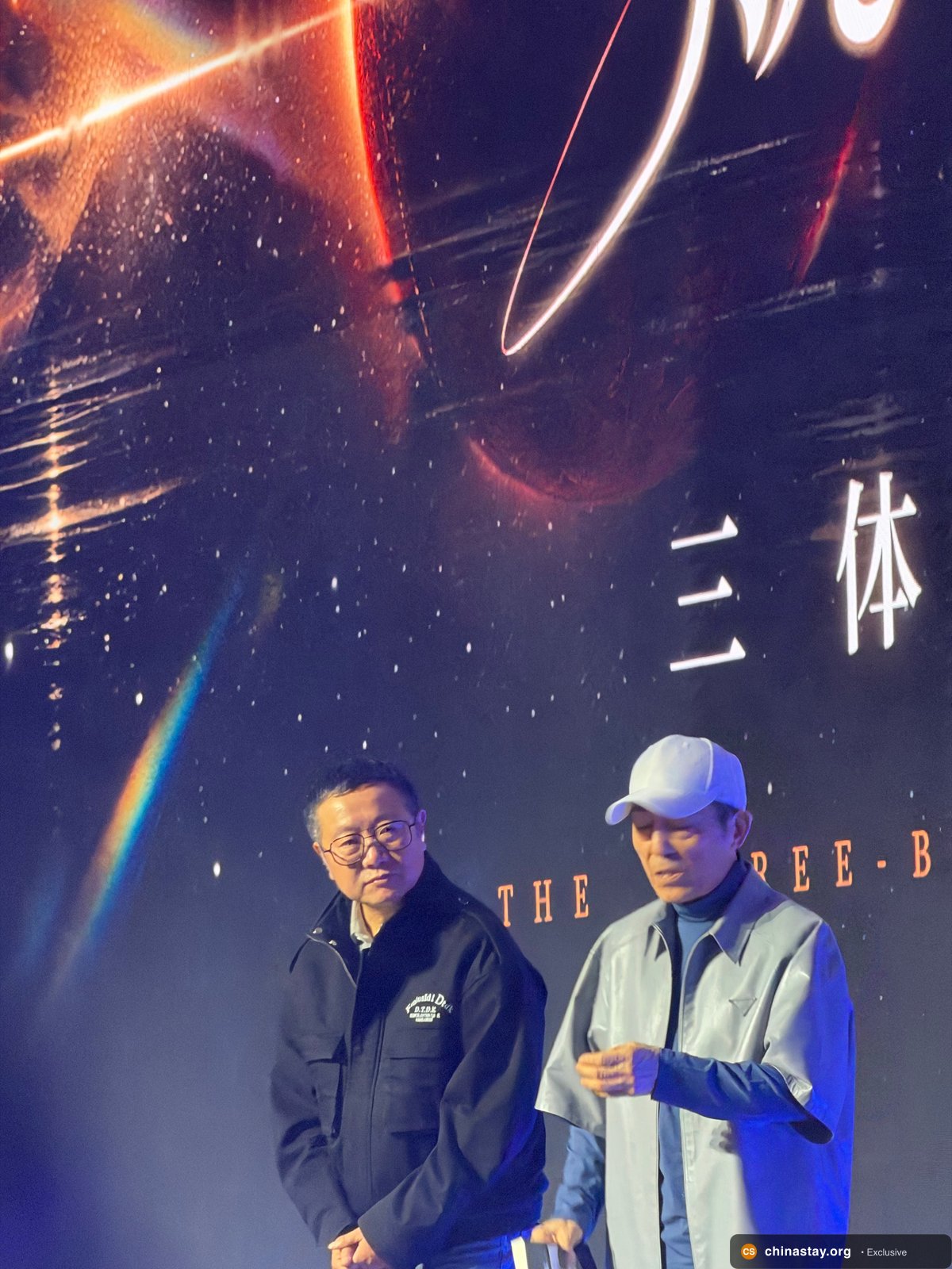 Exclusive photo of Cixin Liu interacting with fans on Three-Body Day in Beijing, discussing the upcoming Three-Body Problem film directed by Zhang Yimou.